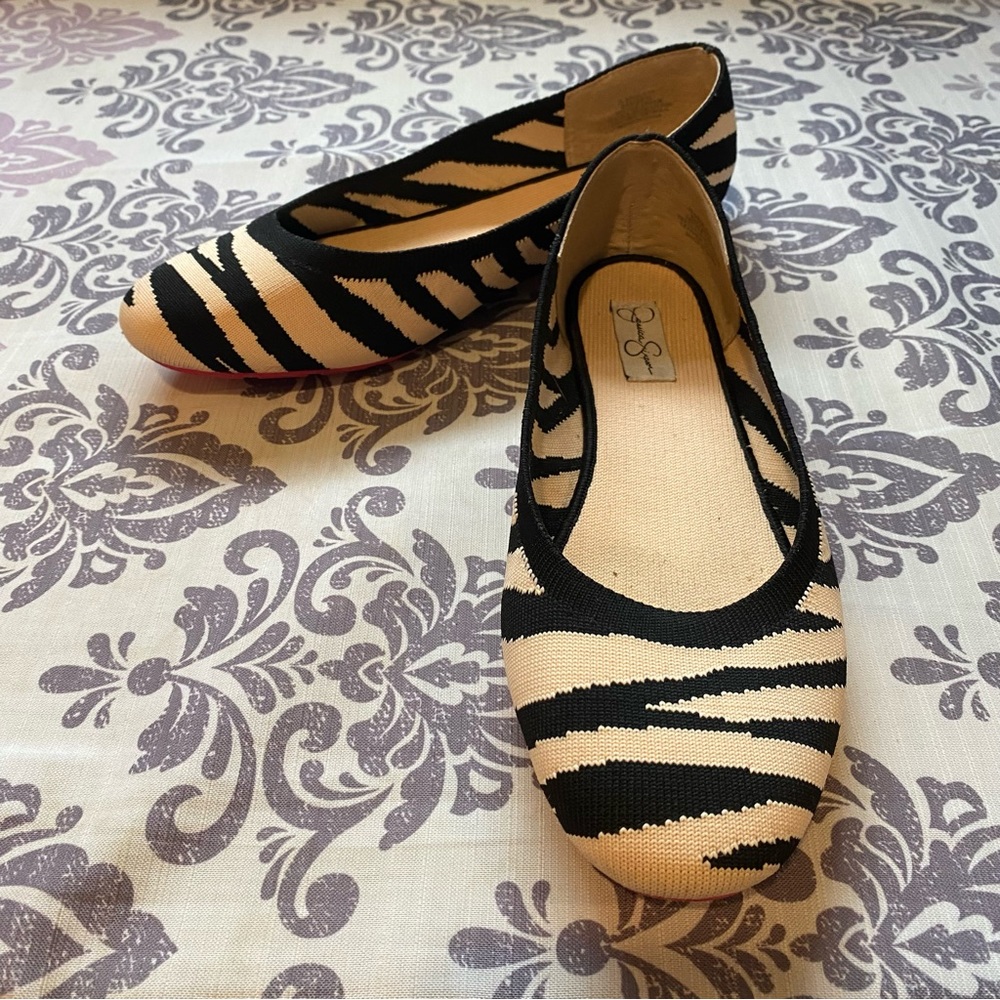 Jessica Simpson zebra striped flats with hot pink soles.